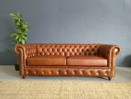 3 Seater Chesterfield in Naku Butterscotch leather with bronze studs and polished wooden legs by Maree Meubels in Brackenfell Cape Town