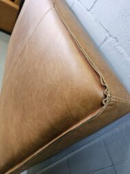 Close up reverse stitch plain leather headboard by Maree Meubels