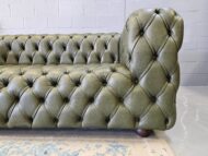 The ChesterCube Leather Sofa Cape Town by Maree Meubels is a handcrafted statement of South African design excellence. This 4-Seater in Heritage Green full-grain leather blends classic Chesterfield elegance with a bold cube silhouette, creating a timeless showpiece for your living space. Each ChesterCube is made with genuine full-grain leather, the highest grade available. The Heritage Green tone adds warmth and sophistication while the deep button tufting displays careful, detailed workmanship. Every side of this sofa is beautifully finished, therefore it looks perfect from any viewing angle. The solid hardwood frame carries a 10-year warranty, and the skilled workmanship a 2-year guarantee. Inside, high-density foam provides comfort and structure that last. Because of its generous 2.6-metre size, it suits both luxury homes and modern apartments. At Maree Meubels, each sofa is built locally in Cape Town using sustainable practices. As a result, every ChesterCube Leather Sofa Cape Town supports skilled artisans and local craftsmanship. In addition, you may custom-order yours in other rich tones such as Naku Curry, Butterscotch, or Oxblood. Moreover, this piece is more than a sofa; it is art with purpose. It brings texture, depth, and character into any interior. Priced at R37 000, the ChesterCube 4-Seater offers remarkable value for a handcrafted full-grain leather design. Explore our full Leather Couches Collection to discover matching pieces, or complete the look with one of our elegant Ottomans. For a deeper look at the history of this timeless design, see Wikipedia’s Chesterfield Sofa page.